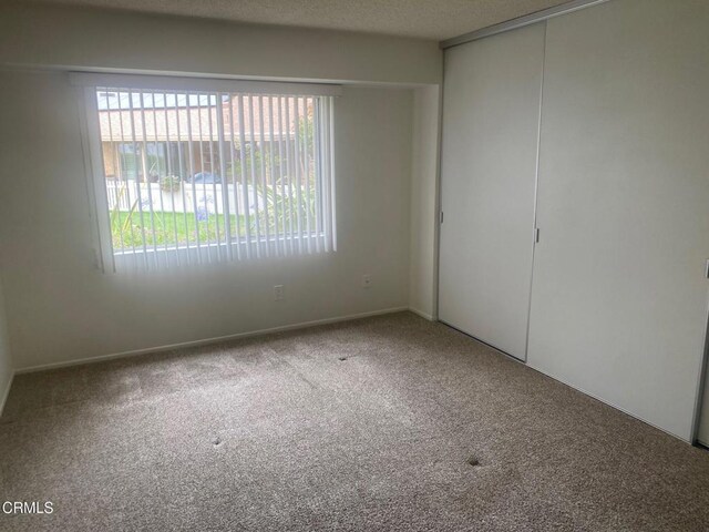 1208 Village 1 Unit 1208, Camarillo, CA 93012 - empty room with carpet and healthy amount of natural light