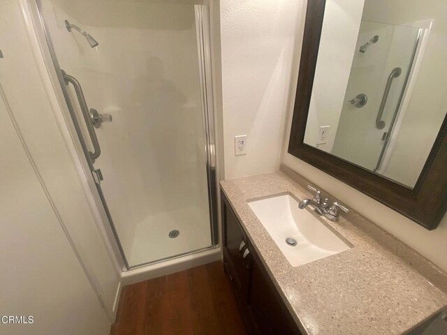 1208 Village 1 Unit 1208, Camarillo, CA 93012 - full bathroom with a stall shower, vanity, and wood finished floors