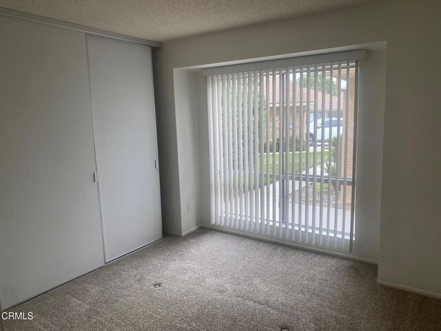1208 Village 1 Unit 1208, Camarillo, CA 93012 - empty room featuring carpet and a textured ceiling