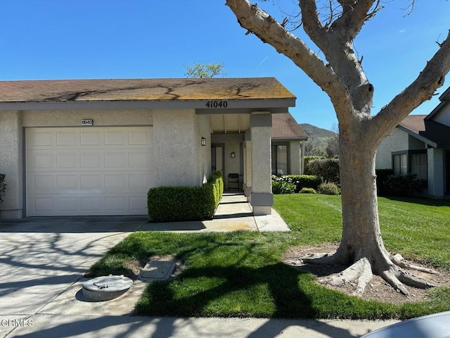 41040 Village 41, Camarillo, CA 93012 - view of front facade with an attached garage, stucco siding, a front yard, and concrete driveway