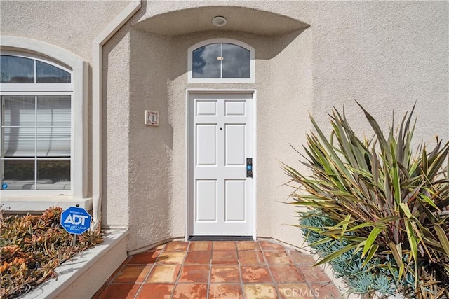 view of exterior entry with stucco siding