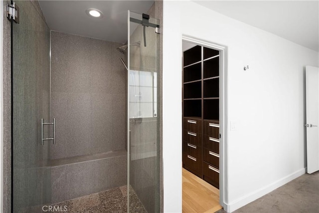 full bath with baseboards, a stall shower, and recessed lighting