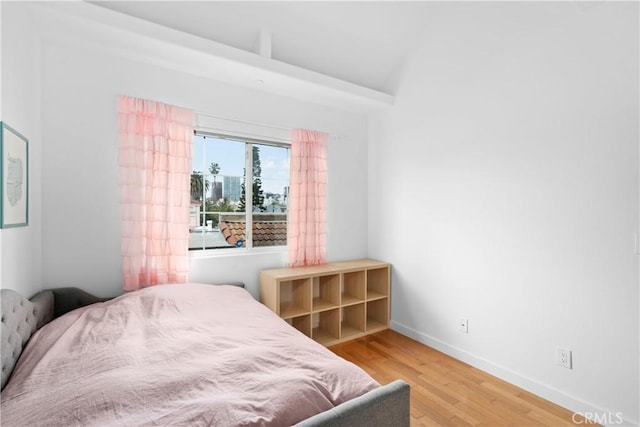 bedroom featuring baseboards and wood finished floors