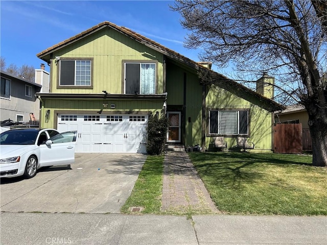 view of front facade featuring driveway, a front yard, a chimney, fence, and an attached garage