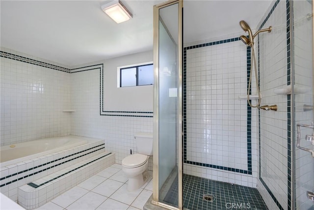 full bath with a shower stall, a garden tub, tile patterned floors, tile walls, and toilet