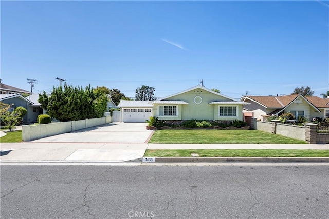 view of front of property featuring driveway, fence, a front yard, a garage, and stucco siding