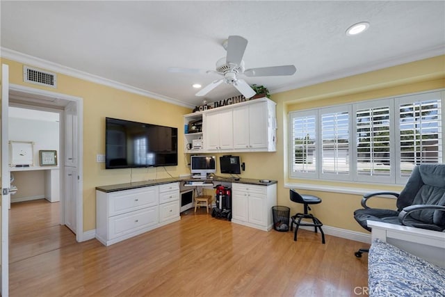 kitchen with dark countertops, visible vents, baseboards, and white cabinetry