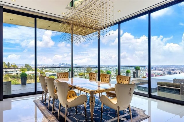 sunroom featuring a city view, tile patterned flooring, and a wall of windows