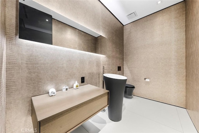 bathroom featuring visible vents and a soaking tub