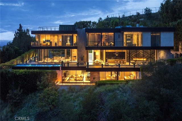 rear view of property featuring a balcony