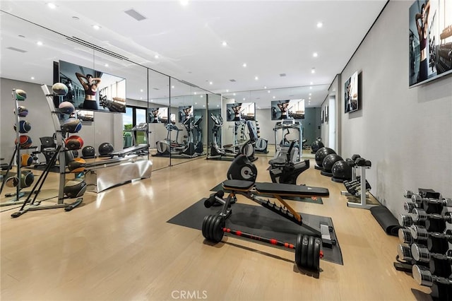 gym featuring visible vents, recessed lighting, and wood finished floors
