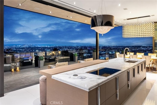 view of patio / terrace featuring exterior kitchen, a sink, and a city view