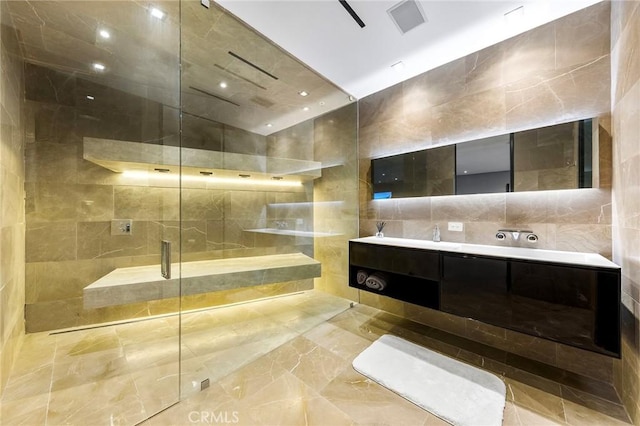 full bath with tile walls, double vanity, and tiled shower