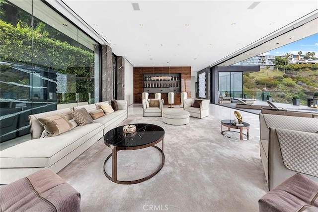 living area with concrete floors and floor to ceiling windows