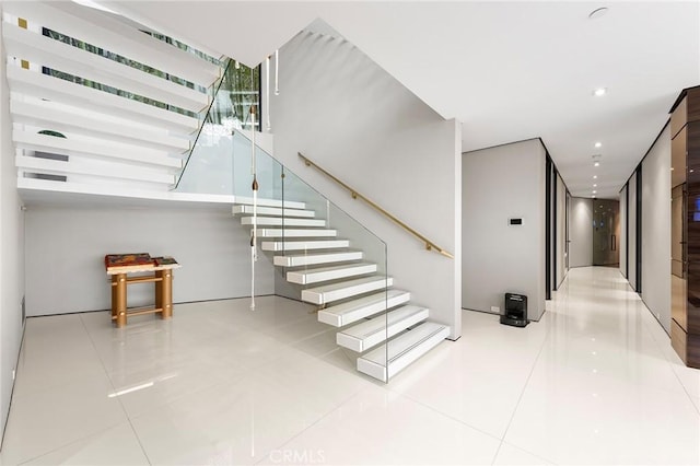 stairway with recessed lighting and tile patterned flooring