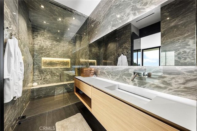 full bath with vanity, tile walls, and a walk in shower