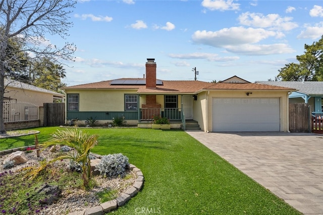 single story home featuring an attached garage, fence, a chimney, and a front yard