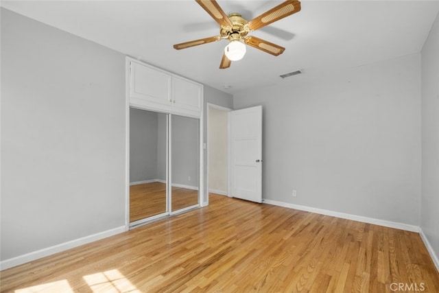 unfurnished bedroom featuring light wood-style flooring, baseboards, ceiling fan, and visible vents