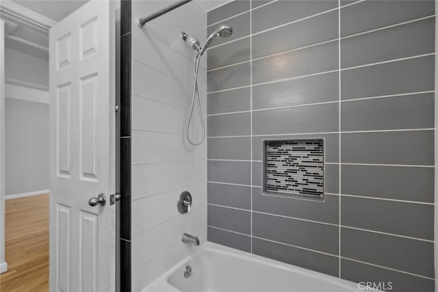 bathroom featuring bathing tub / shower combination and wood finished floors