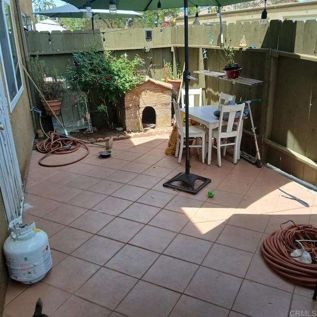 2041 E Grand Ave Unit 48, Escondido, CA 92027 - view of patio / terrace featuring fence, outdoor dining space, and a shed