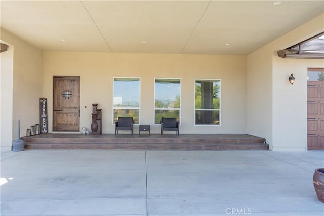 doorway to property with stucco siding
