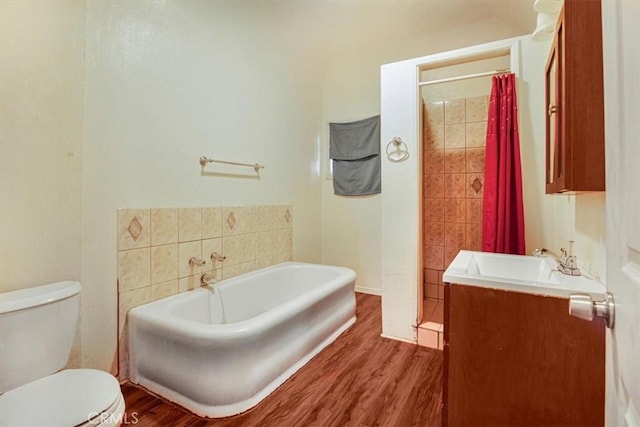 3417 4th Ave, Los Angeles, CA 90018 - full bath with a garden tub, vanity, toilet, curtained shower, and wood finished floors