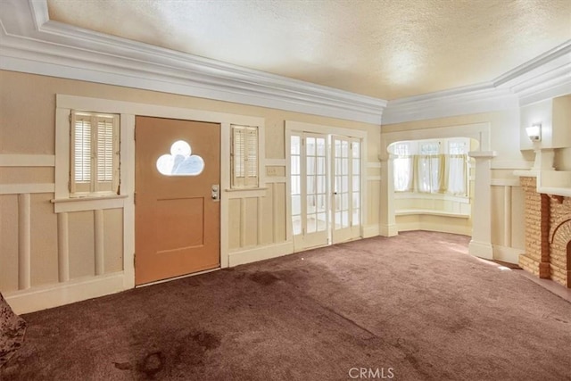 3417 4th Ave, Los Angeles, CA 90018 - carpeted foyer entrance featuring a fireplace, a textured ceiling, and ornamental molding