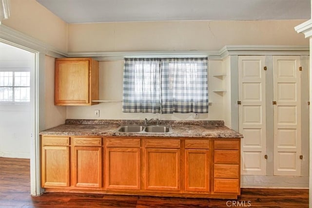 3417 4th Ave, Los Angeles, CA 90018 - kitchen featuring a sink, brown cabinets, dark countertops, and dark wood-type flooring