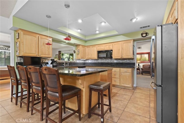 3291 Lemon Dr, Simi Valley, CA 93063 - kitchen featuring freestanding refrigerator, black microwave, light brown cabinetry, a kitchen bar, and light tile patterned flooring