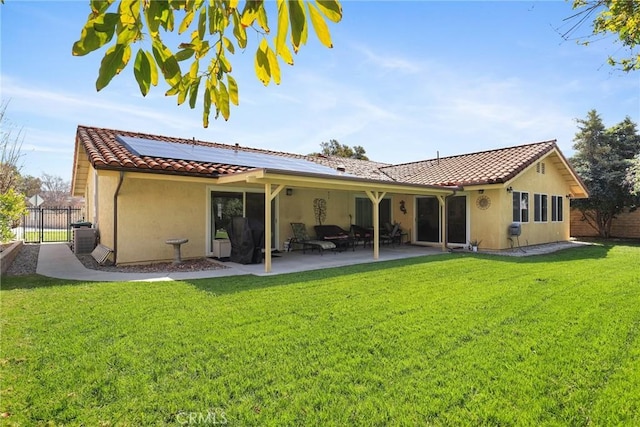 3291 Lemon Dr, Simi Valley, CA 93063 - back of house with stucco siding, roof mounted solar panels, a tiled roof, and a patio