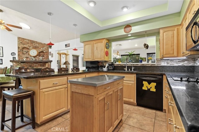 3291 Lemon Dr, Simi Valley, CA 93063 - kitchen featuring black appliances, a kitchen island, a sink, a ceiling fan, and a kitchen breakfast bar