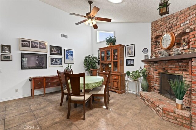 3291 Lemon Dr, Simi Valley, CA 93063 - dining area featuring ceiling fan, a textured ceiling, a fireplace, high vaulted ceiling, and baseboards