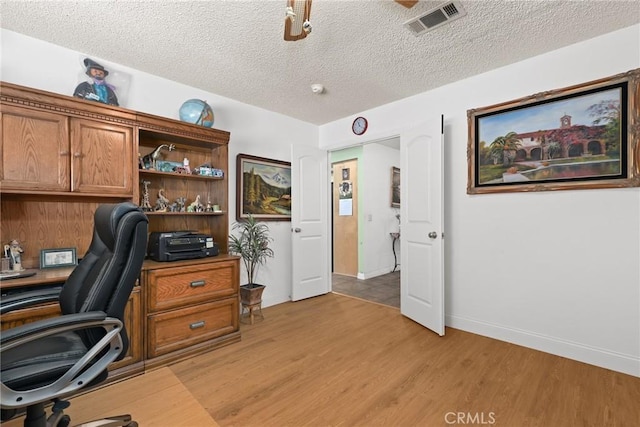 3291 Lemon Dr, Simi Valley, CA 93063 - home office with light wood finished floors, a textured ceiling, and baseboards