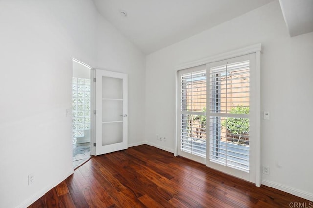 unfurnished room featuring baseboards, french doors, wood finished floors, and high vaulted ceiling