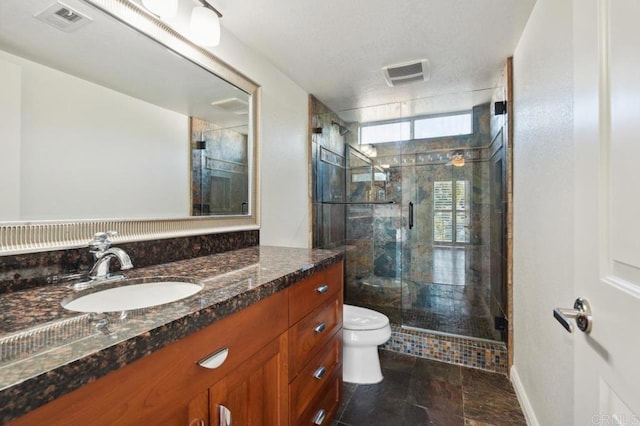 full bath featuring visible vents, a stall shower, toilet, and vanity