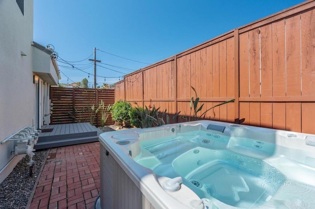 view of patio / terrace featuring a hot tub and a fenced backyard