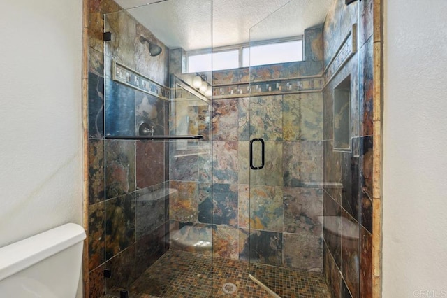 full bath with toilet and a stall shower