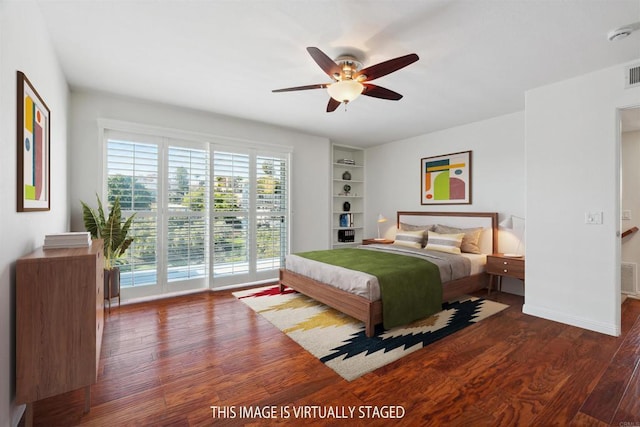 bedroom featuring ceiling fan, access to exterior, wood finished floors, and visible vents