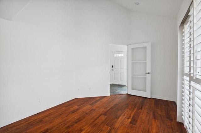 empty room featuring baseboards and wood finished floors