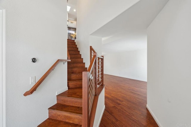 staircase featuring wood finished floors