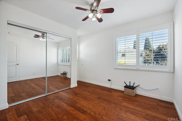 unfurnished bedroom featuring a closet, a ceiling fan, baseboards, and wood finished floors