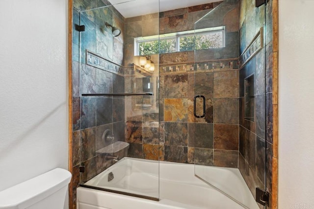 full bath with shower / bath combination with glass door and toilet