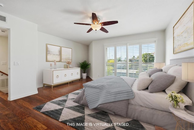 bedroom with baseboards, ceiling fan, wood finished floors, and visible vents