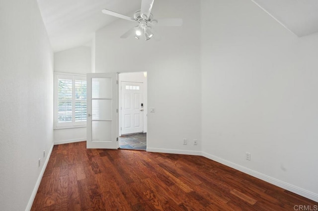 empty room featuring baseboards, a ceiling fan, wood finished floors, and high vaulted ceiling