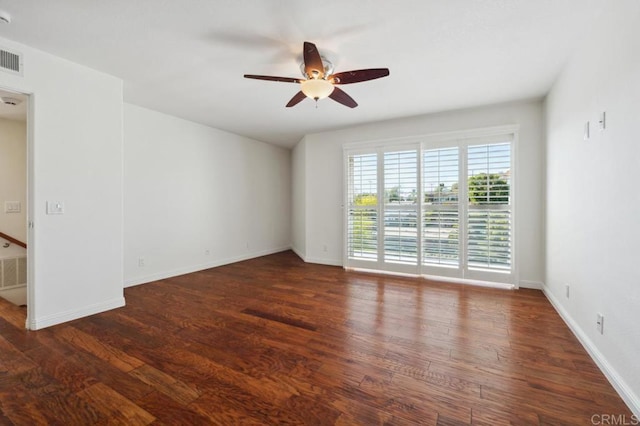 spare room with baseboards, ceiling fan, wood finished floors, and visible vents