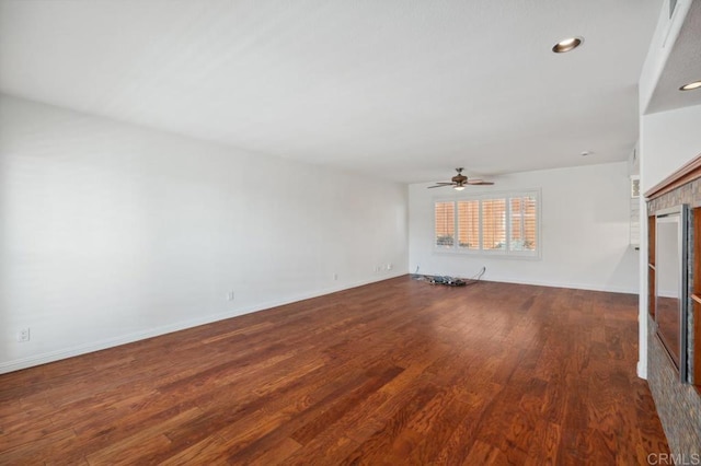 unfurnished living room featuring wood finished floors, a fireplace, baseboards, ceiling fan, and recessed lighting
