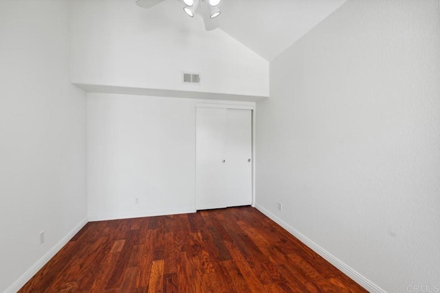 interior space with visible vents, vaulted ceiling, wood finished floors, baseboards, and a closet