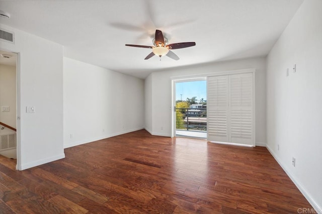 spare room featuring baseboards, ceiling fan, and wood finished floors