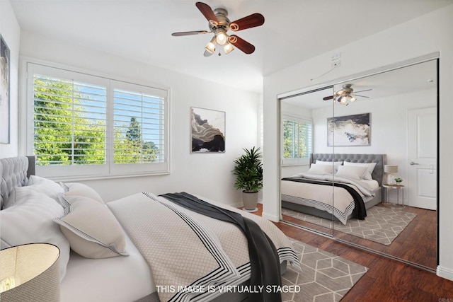 bedroom featuring ceiling fan, a closet, and wood finished floors