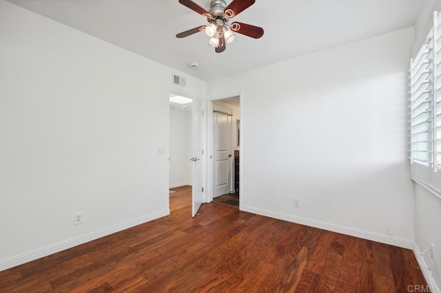 unfurnished bedroom featuring a ceiling fan, baseboards, visible vents, and wood finished floors